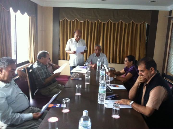 FEDUC executive committee members around a meeting table with papers and water bottles