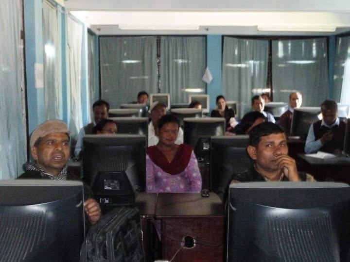 Teachers of different ages working at computers during training