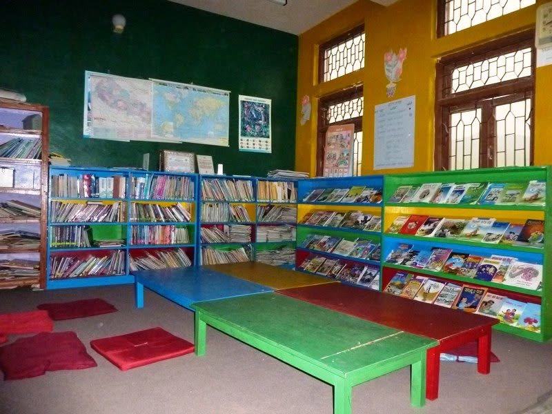 Colourful bookshelves and low reading tables in the library of Shree Khandapur Primary School