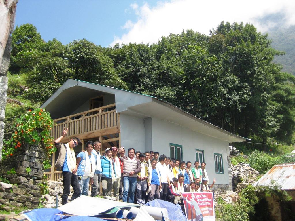 Young trainees of FEDUC’s Special Skills Development Program gather in front of a house they built in Lukla, Solukhumbu